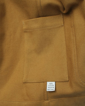 inside pocket detail of a mustard cotton jacket