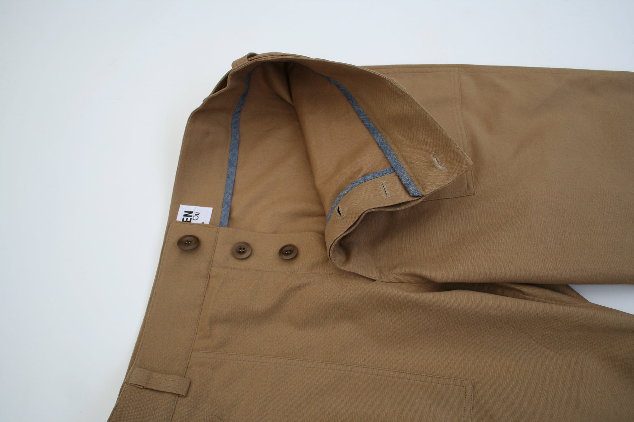 close up image of the fly on a pair of menswear chore trousers made in tan brushed cotton canvas