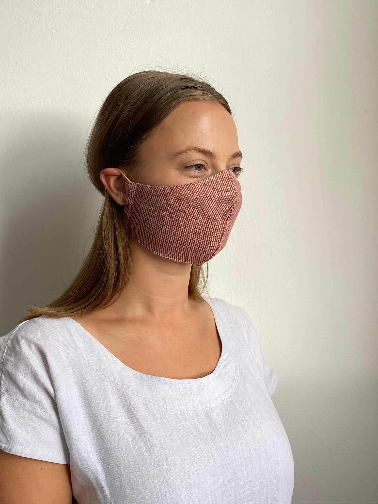 a girl wearing a checked cotton facemask made in the UK