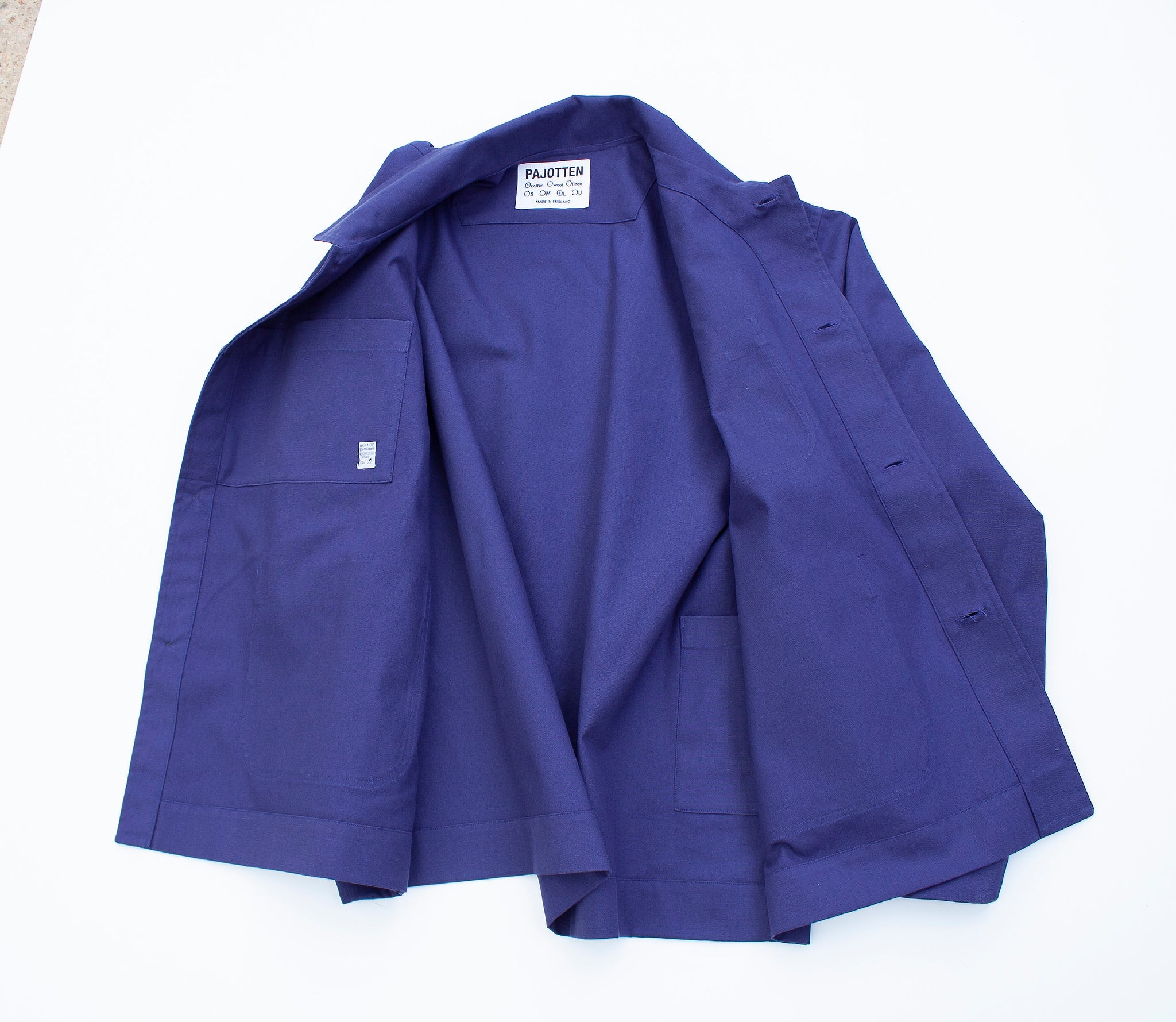 the inside view of an indigo tradional chore jacket made in brushed cotton canvas